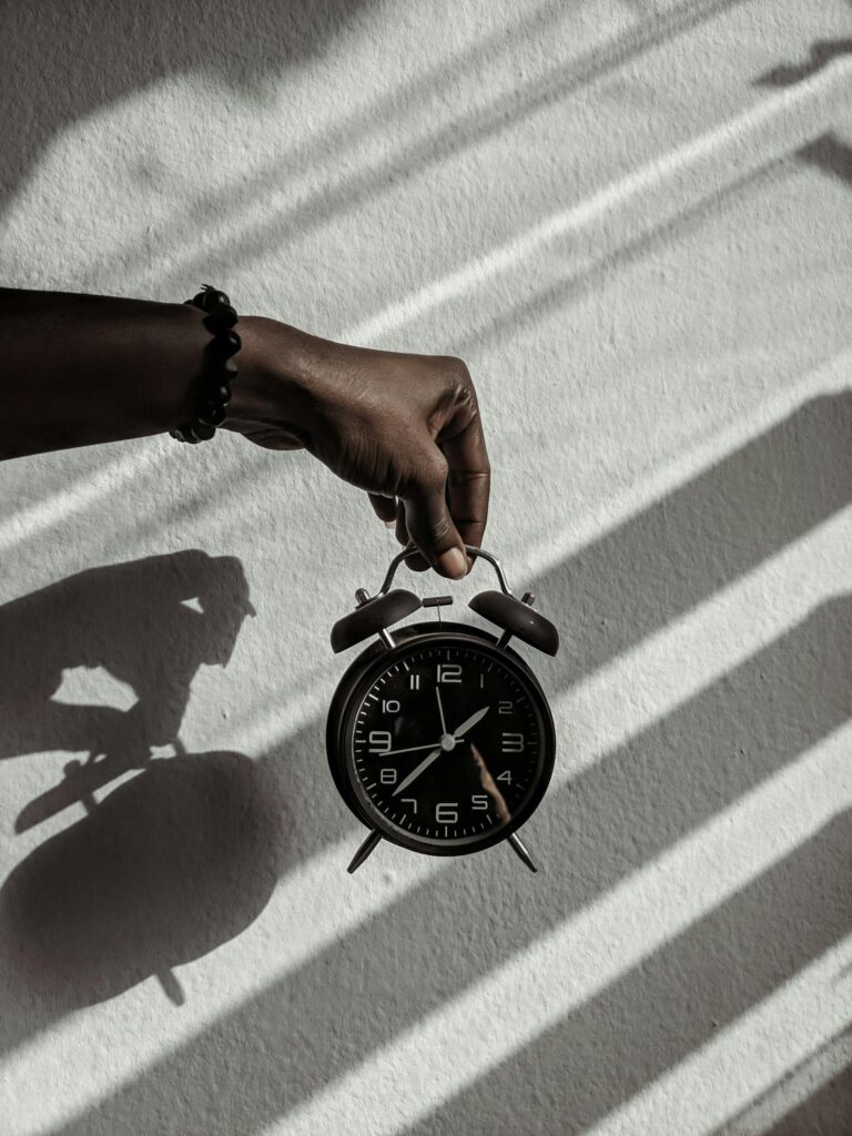 Person Holding a Alarm Clock