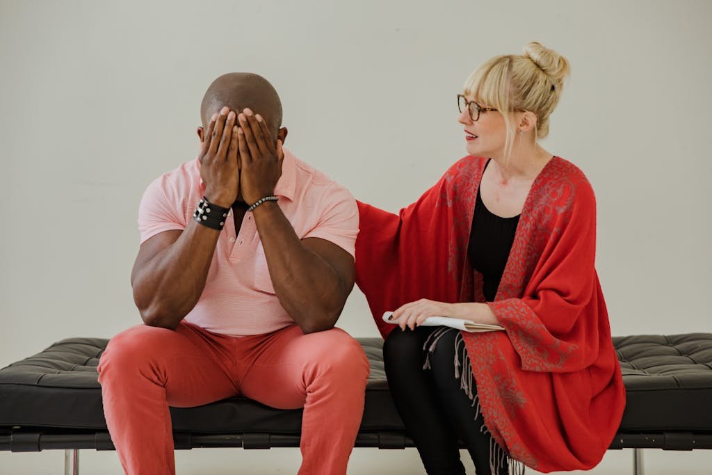 Bald Man Sitting on Bench with a Woman in Red Shawl